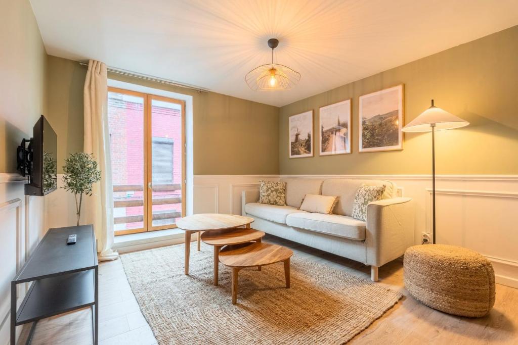 a living room with a couch and a table at 1 bedroom courtyard house typical of Old Lille in Lille