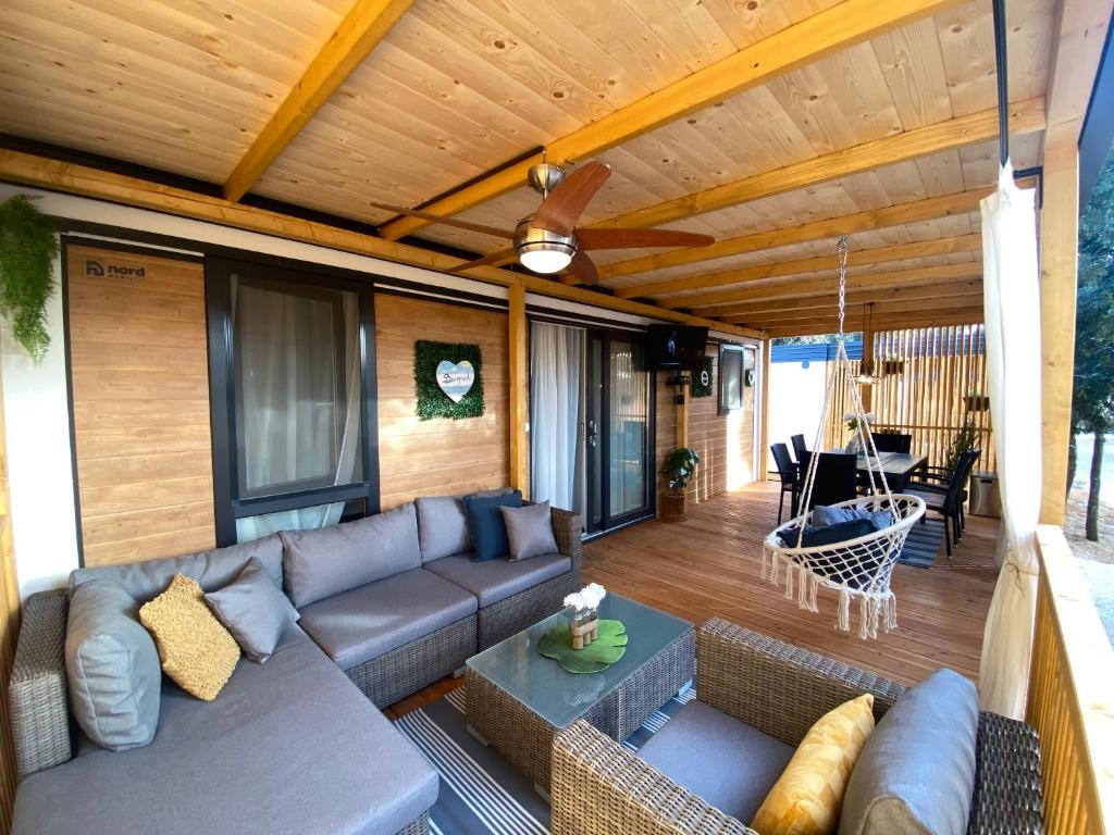 a living room with a couch and a table at Summer Stay - Mobile Home in Biograd na Moru