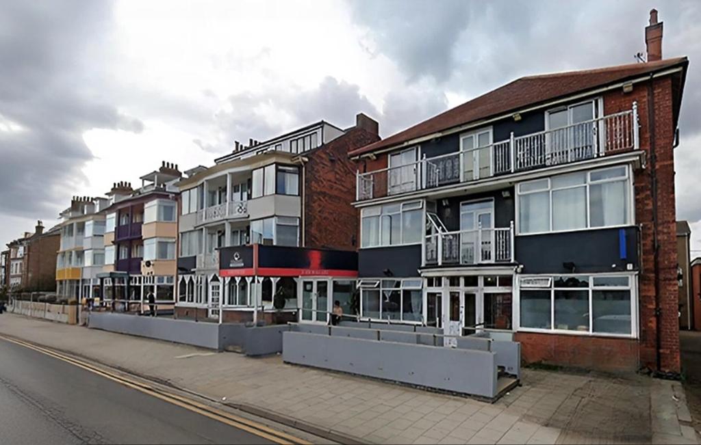 a row of apartment buildings on a city street at Sea Side Hotel in Skegness