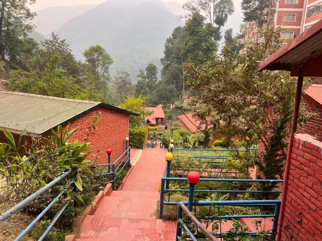 a stairway leading up to a building with mountains in the background at Hotel View Salleri in Kathmandu