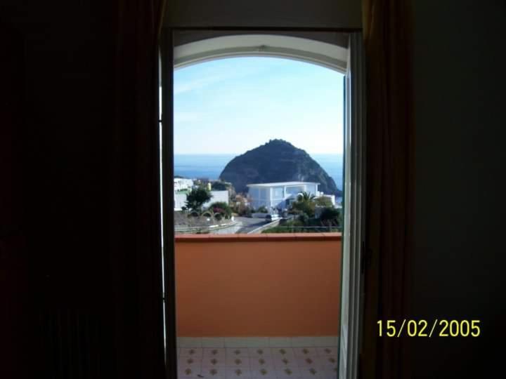 an open door with a view of the ocean at Casa La Perla in Ischia