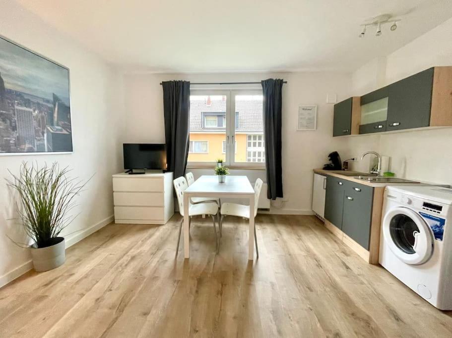 ケーニヒスヴィンターにあるCharmantes Apartment mit 3 Bettenのキッチン(テーブル、洗濯機付)