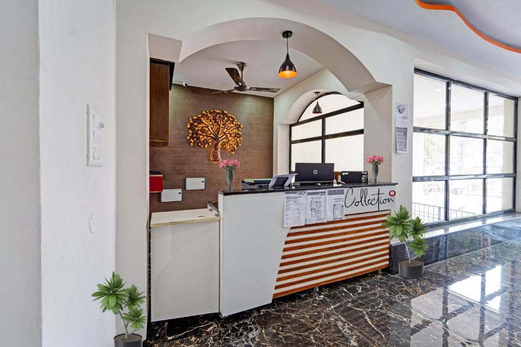 a lobby of a hotel with a reception counter at Capital O Hotel Lakshmi Residency in Tirupati