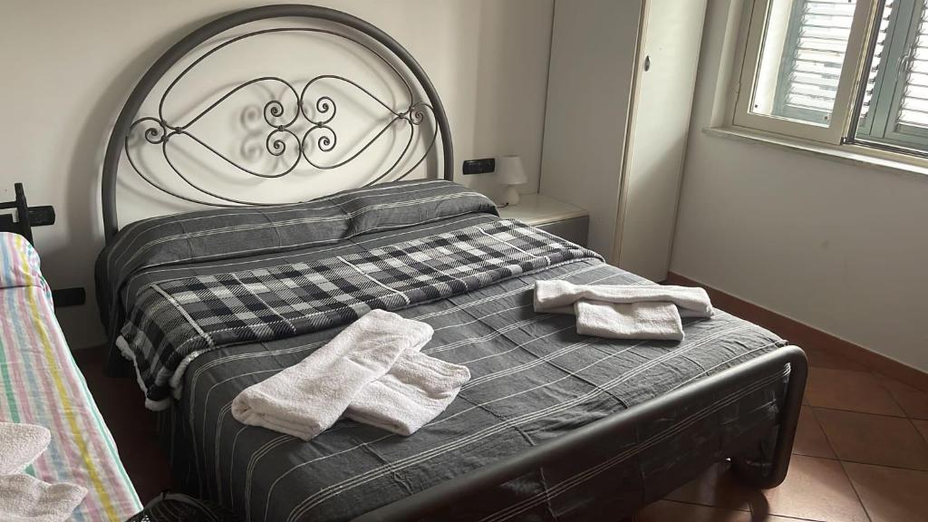 a bedroom with a bed with two towels on it at Il Marinaio in Messina