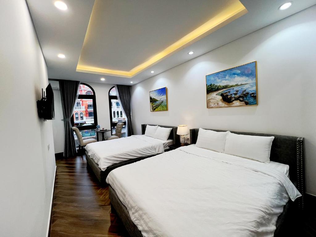 מיטה או מיטות בחדר ב-Legacy Phú Quốc