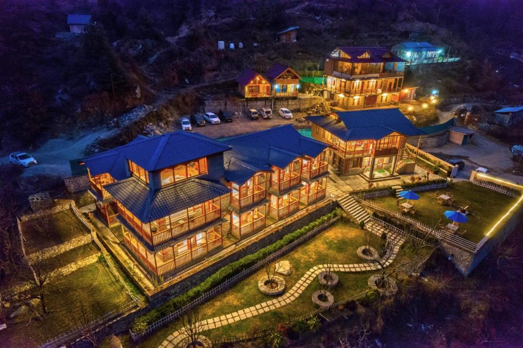 an aerial view of a mansion at night at The Blue Stream Cottage in Jibhi