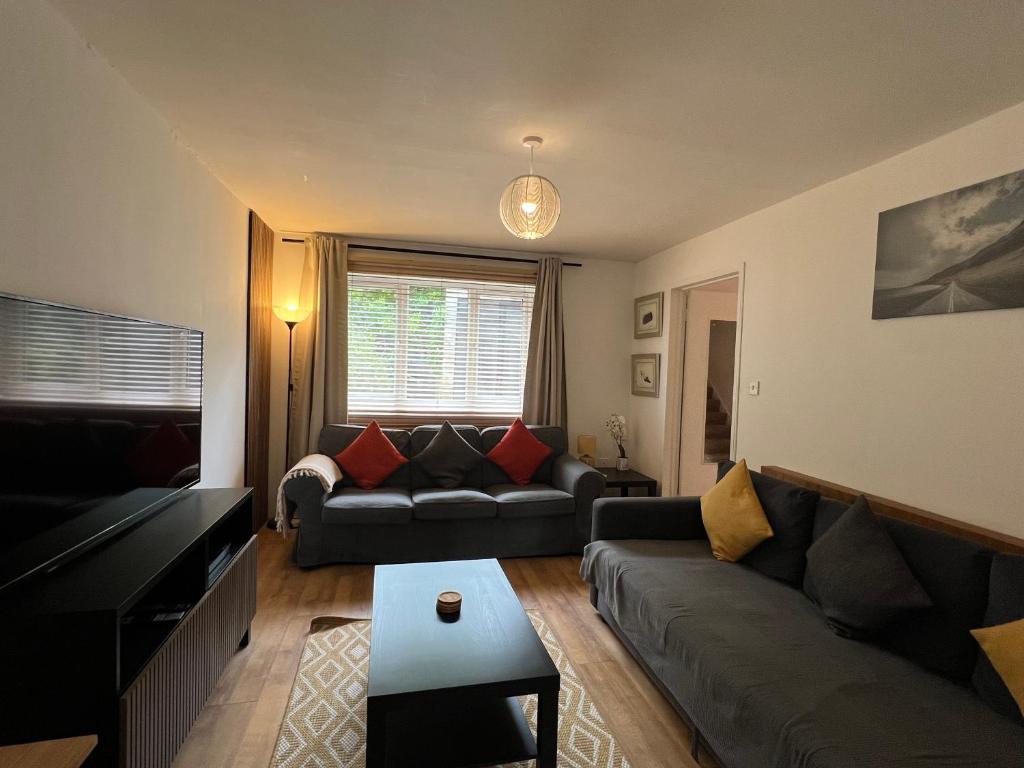 a living room with a couch and a table at 3 Bedroom Town House in Central Muswell Hill London in London