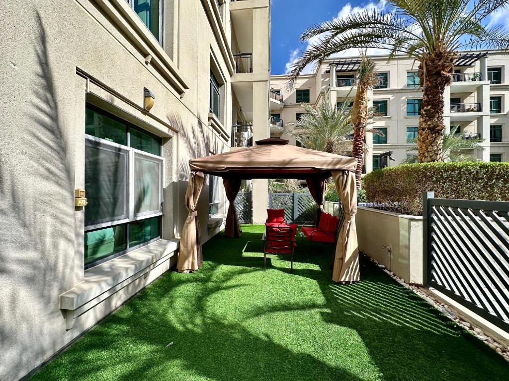 a gazebo on the side of a building at Lux BnB Travo Tower I Private Garden I Lake View in Dubai