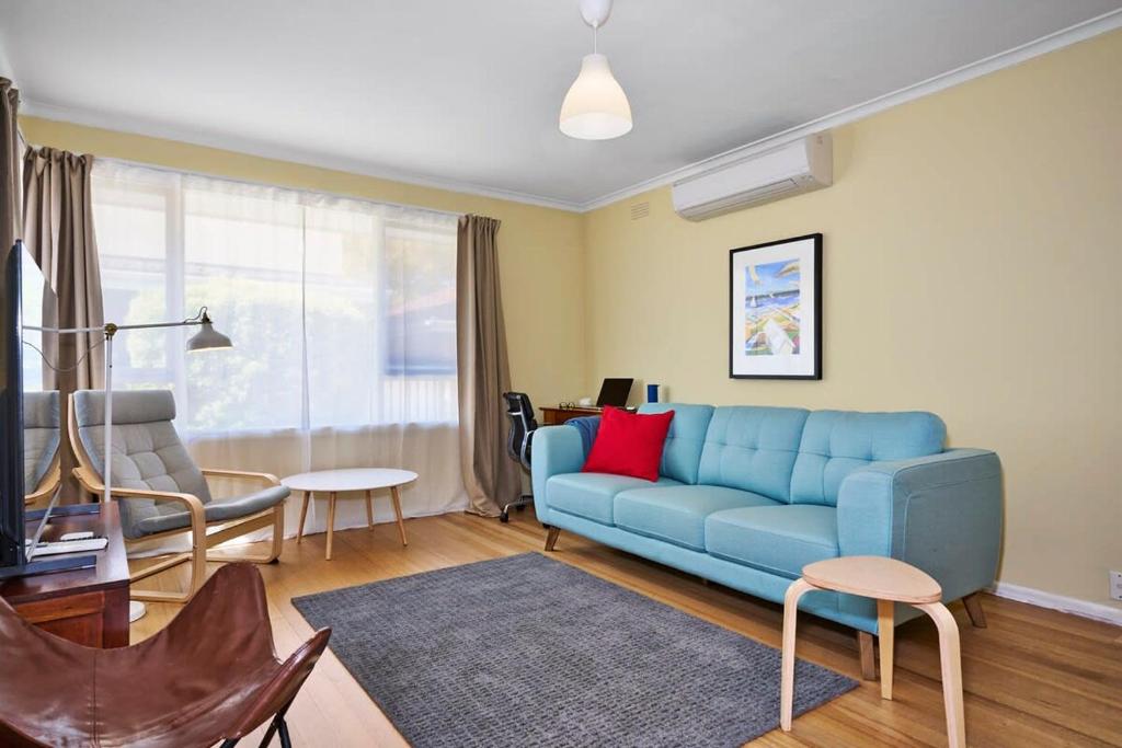 a living room with a blue couch and chairs at Ocean Blue Haven Beachside 2-Bed Unit in Hampton in Melbourne