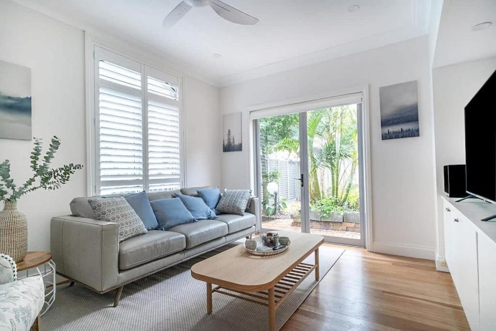 a living room with a couch and a table at Stylish Home in the heart of Newtown in Sydney