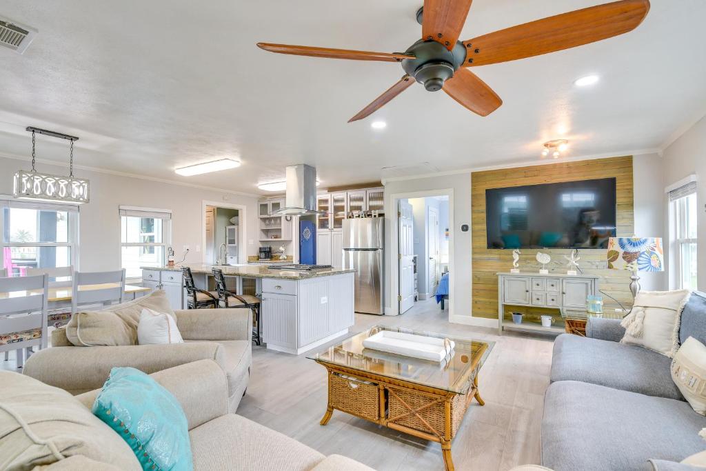 a living room with a couch and a ceiling fan at Lovely Crystal Beach House with Deck Walk to Ocean! in Crystal Beach