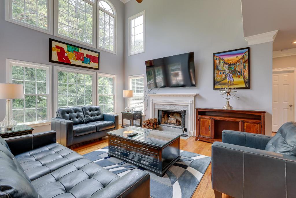 a living room with couches and a fireplace at Spacious Home about 7 Mi to Stone Mountain Park! in Stone Mountain
