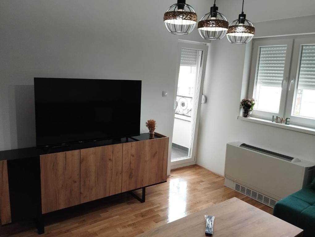 a living room with a flat screen tv on a entertainment center at Stan na dan Bijeljina Niki 2 in Bijeljina