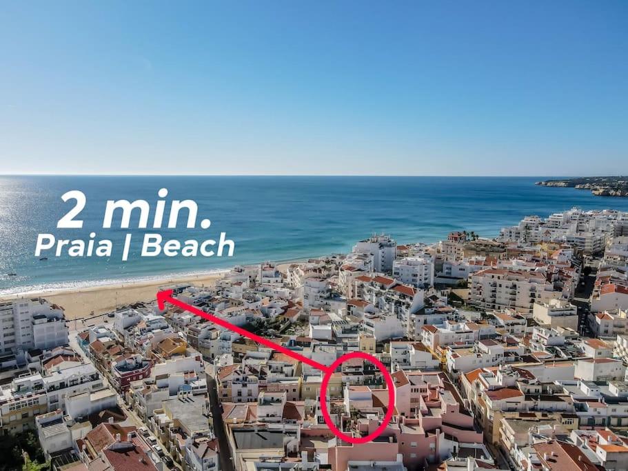 a view of a city with a red arrow pointing to a beach at Perfect house close to beach in Armação de Pêra