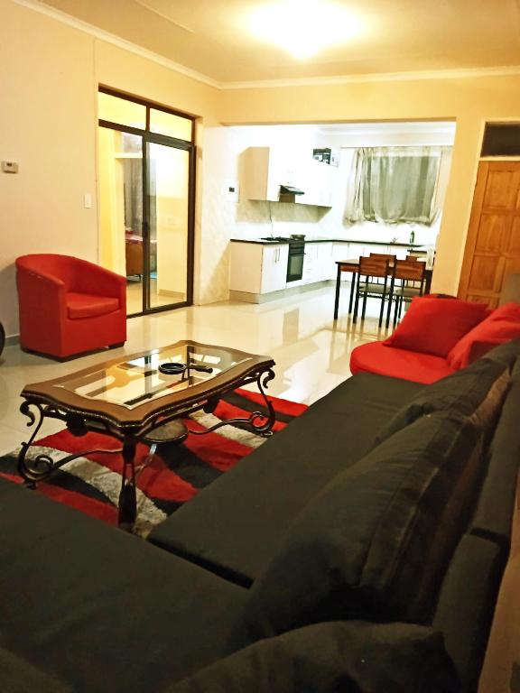 a living room with a couch and a coffee table at BEST APARTMENTS in Mbabane