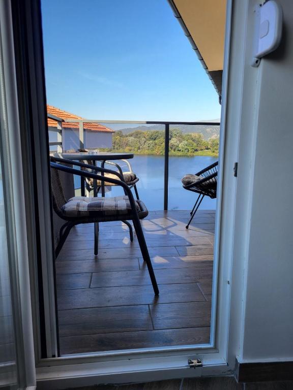 a view from the door of a porch with a table and chairs at Apartman J72 in Ostrovo