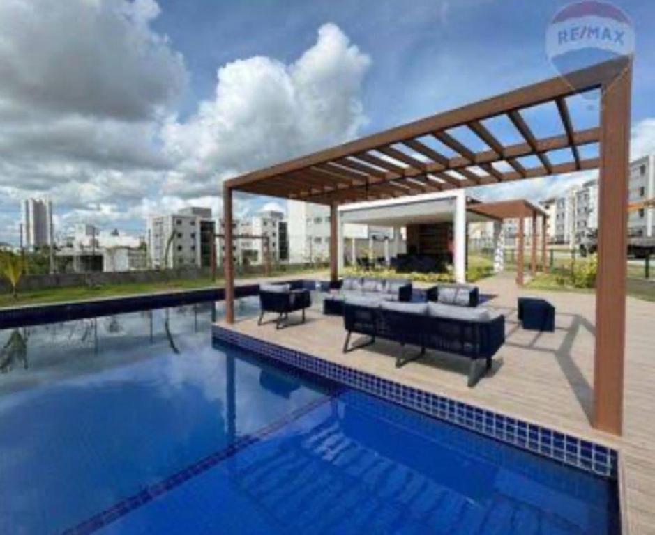 a swimming pool with a pavilion on top of a building at Standard Garden 02 in Caruaru