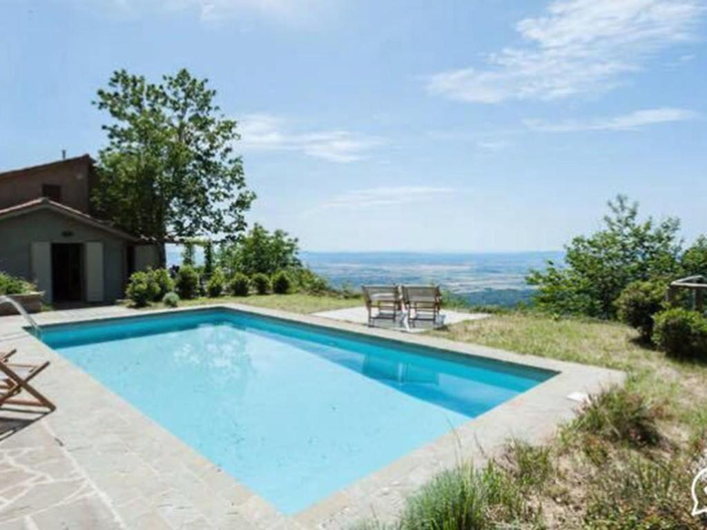 a swimming pool in a yard with a view at Holiday Home Bellavista by Interhome in Cortona
