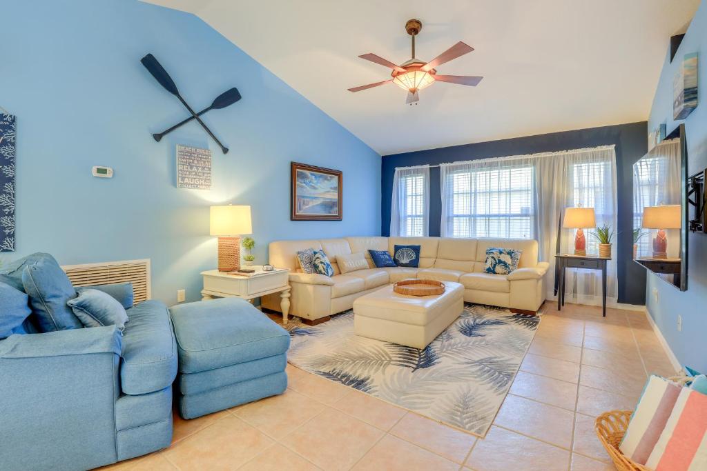 a living room with couches and a ceiling fan at Jensen Beach Home with Heated Pool! in Jensen Beach