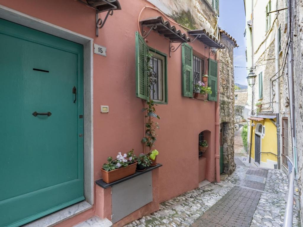 an alley in an old town with a blue door at Holiday Home Kicca by Interhome in Sanremo