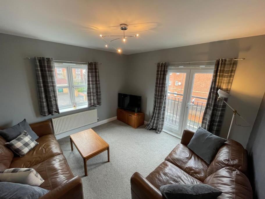 a living room with a couch and a table at Seaham Sea View 2 bedroom apartment in Seaham