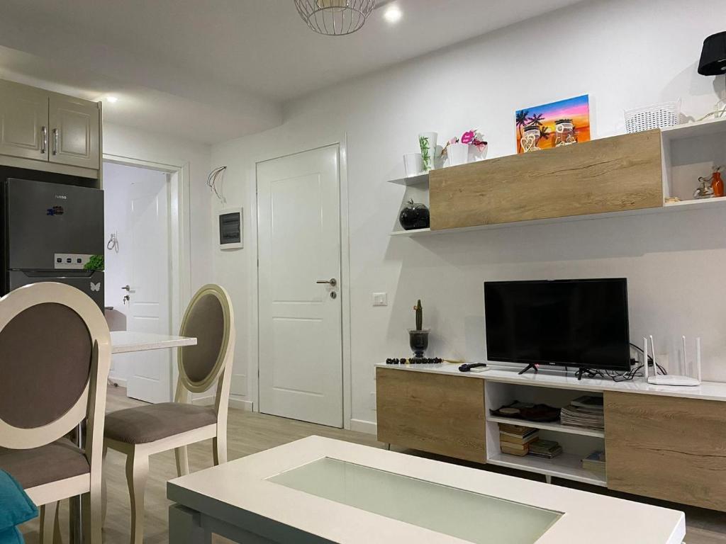 a living room with a flat screen tv on a wall at gabriela apartments in Sarandë