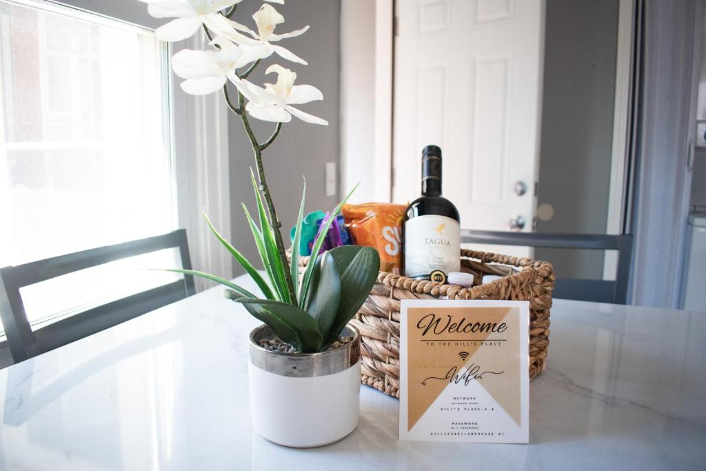 a basket of wine and a plant on a table at Cozy Vacation Home 4 miles from Airport in Cleveland