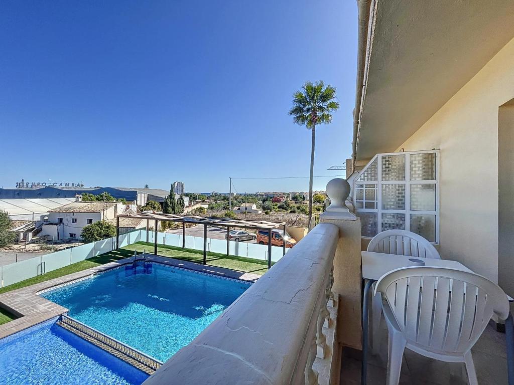 a balcony with a swimming pool and a table and chairs at Hotel Noguera El Albir in Albir