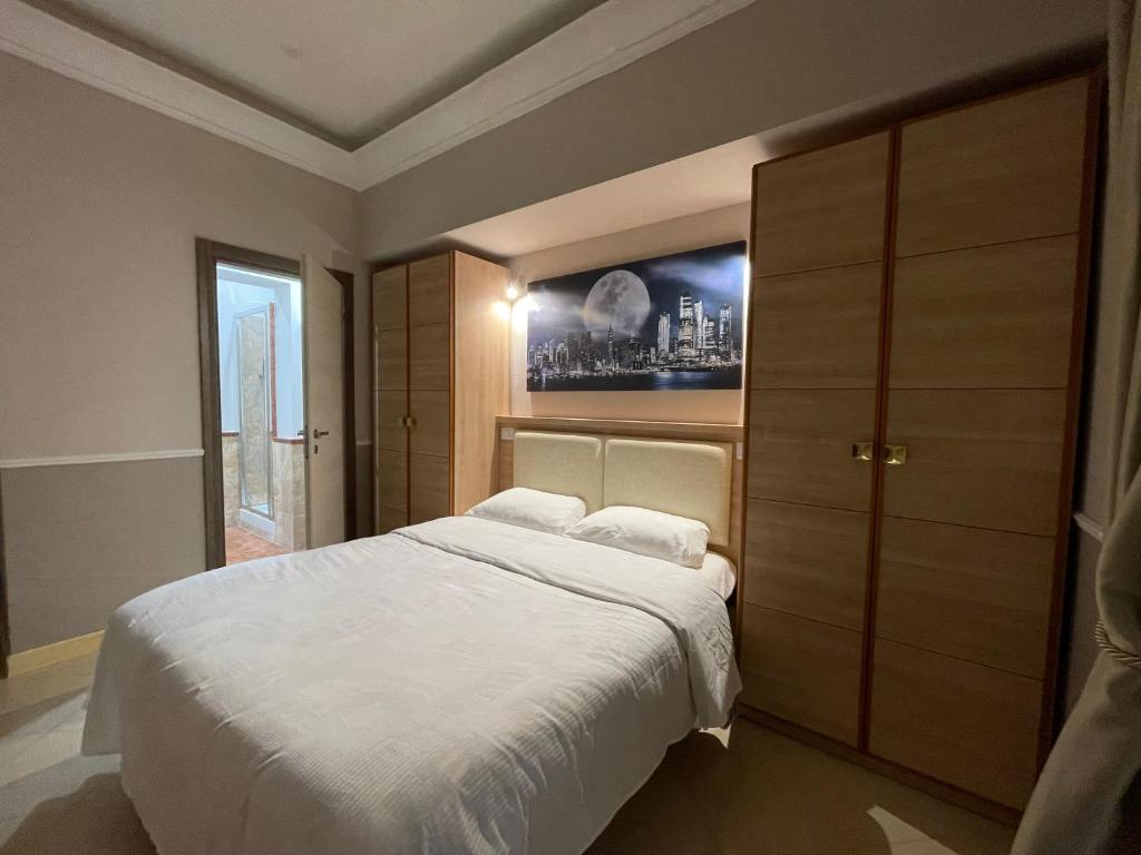a bedroom with a bed and a painting on the wall at Guest House Spqr Suite in Rome
