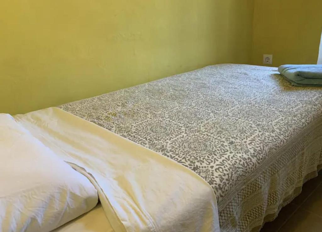 ein Schlafzimmer mit einem Bett mit einer weißen Tagesdecke in der Unterkunft Cal Millo in Vilella Alta
