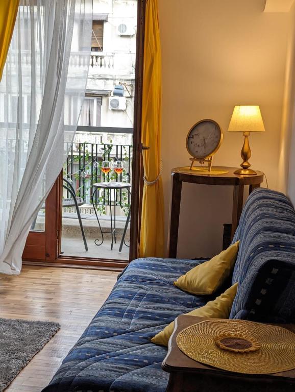 a bedroom with a bed and a door with a balcony at Old Town Studio - Victoriei 2 in Bucharest