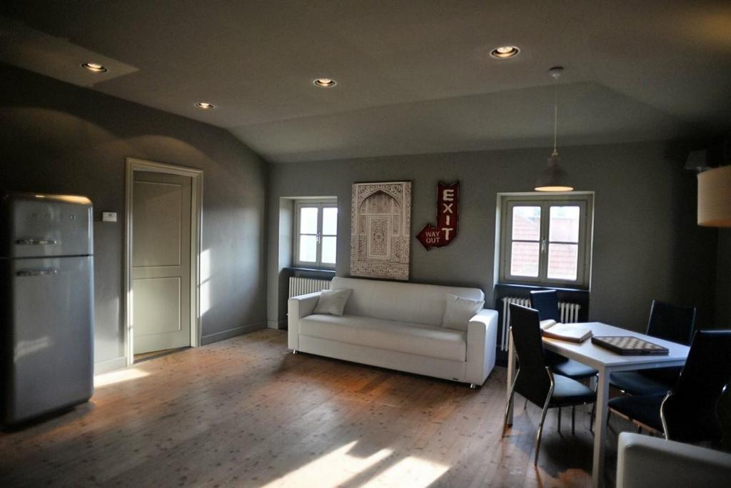 a living room with a white couch and a table at Villa Margherita appartamento per 5 in Villa ottocentesca in Castiglione Chiavarese
