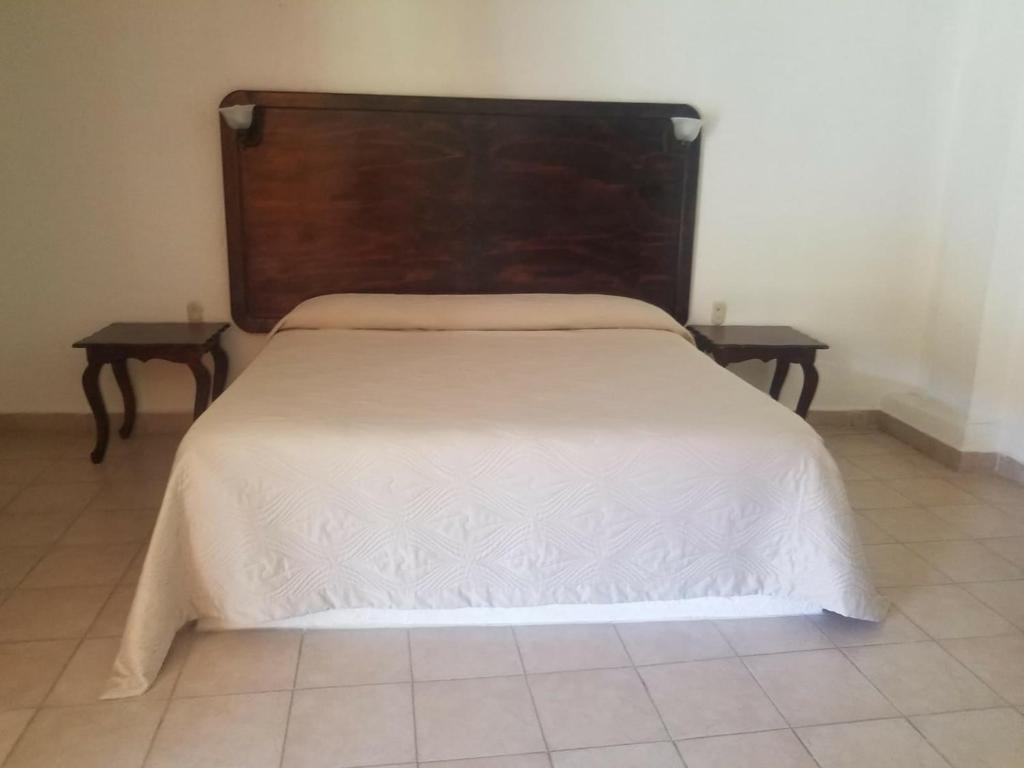Postel nebo postele na pokoji v ubytování Hotel Ollin Teotl