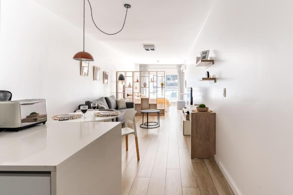 a kitchen and living room with white walls and a counter at Charming apart in Palermo in Buenos Aires