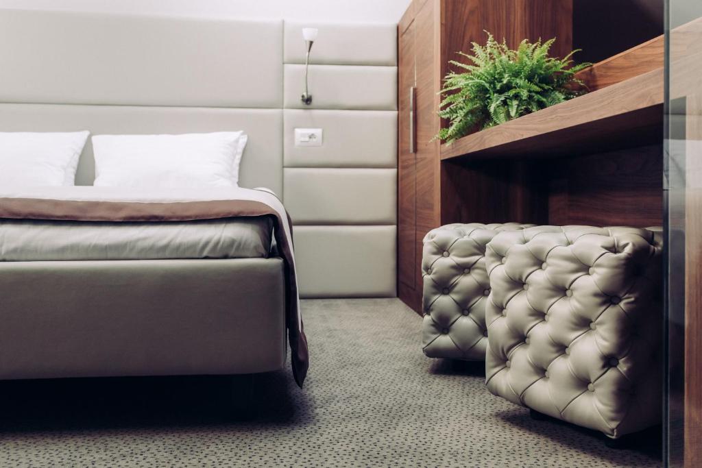 Postel nebo postele na pokoji v ubytování UNO Design Hotel