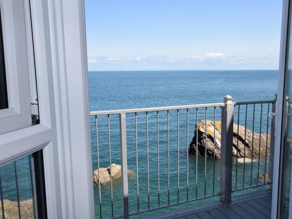 a view of the ocean from a balcony at 2 Bed in Ilfracombe CLOSE in Ilfracombe