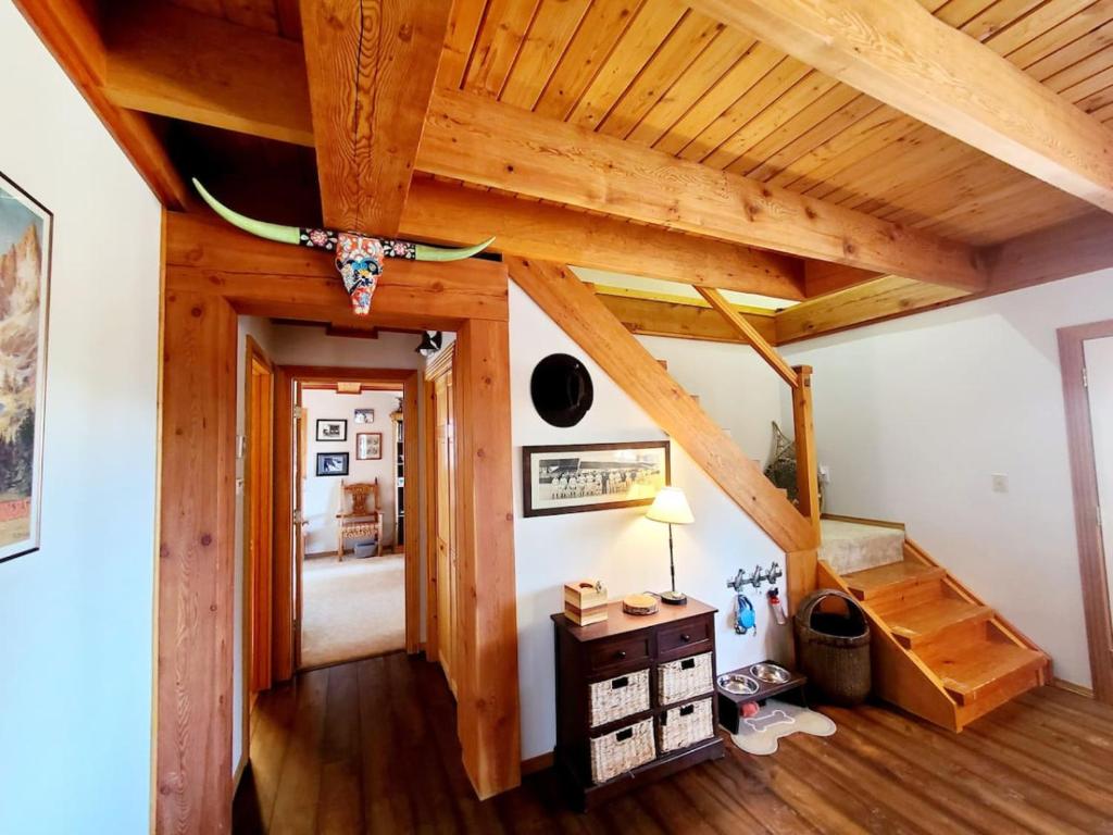 a room with a wooden ceiling with a surfboard on the wall at Blacktail Cabin Hideaway with hot tub in Lakeside