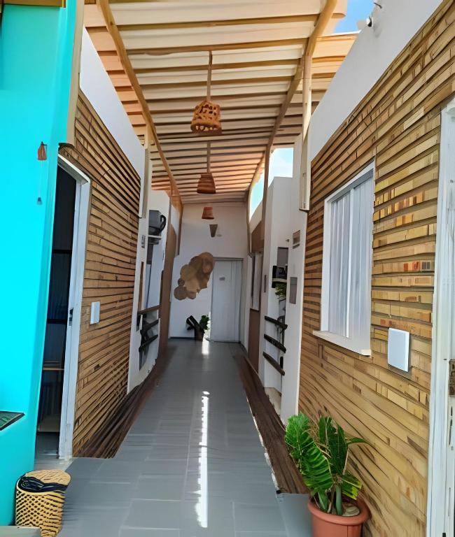 a hallway of a house with wooden walls and ceilings at Hospedaria Mandacaru in Canoa Quebrada