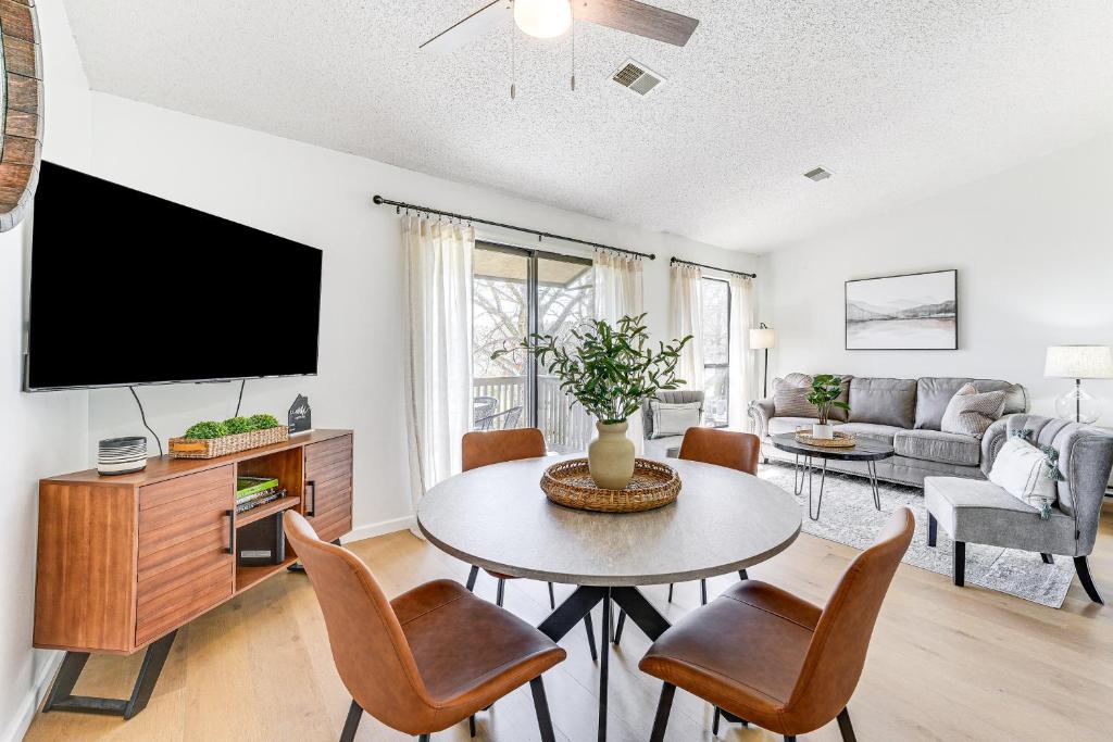 a living room with a table and a tv at 5 Mi to Strip! Pointe Royale Condo w/ Indoor Pool in Branson