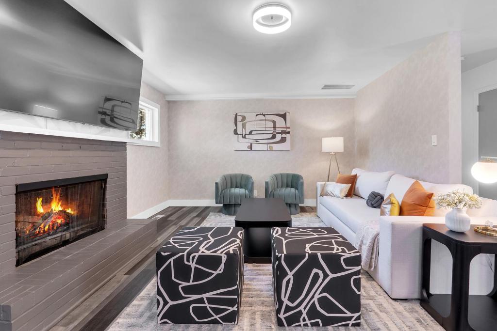 a living room with a couch and a fireplace at 10min to EXPO - Family-Friendly with Office & Playroom in Tulsa