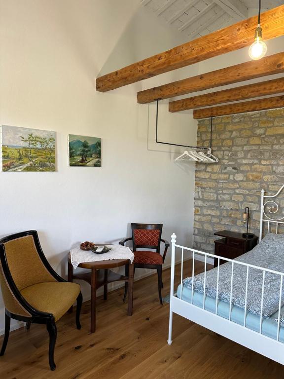 a bedroom with a bed and a table and chairs at Istrian green house in Portorož