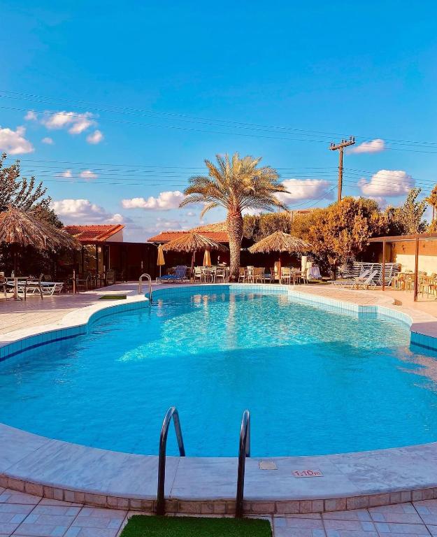 a large pool with blue water in a resort at Karteros Hotel in Karteros