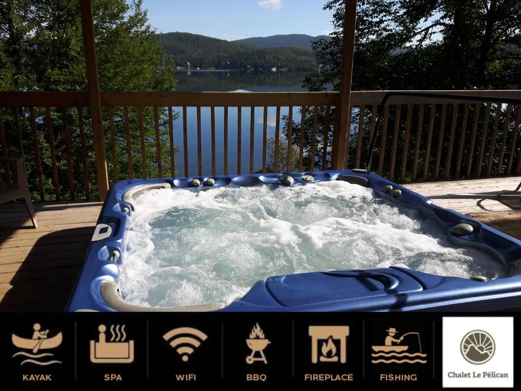 a jacuzzi tub with snow on a deck at Chalet Le Pélican in Lac-Superieur