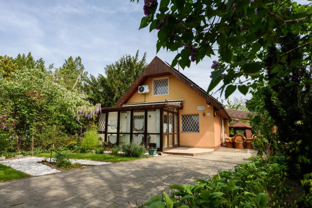 a house with a large driveway in front of it at Emili Apartman Ráckeve in Ráckeve