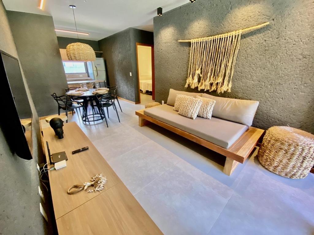 ein Wohnzimmer mit einem Sofa und einem Tisch in der Unterkunft Villas Manatee Milagres C006 in Pôrto de Pedras