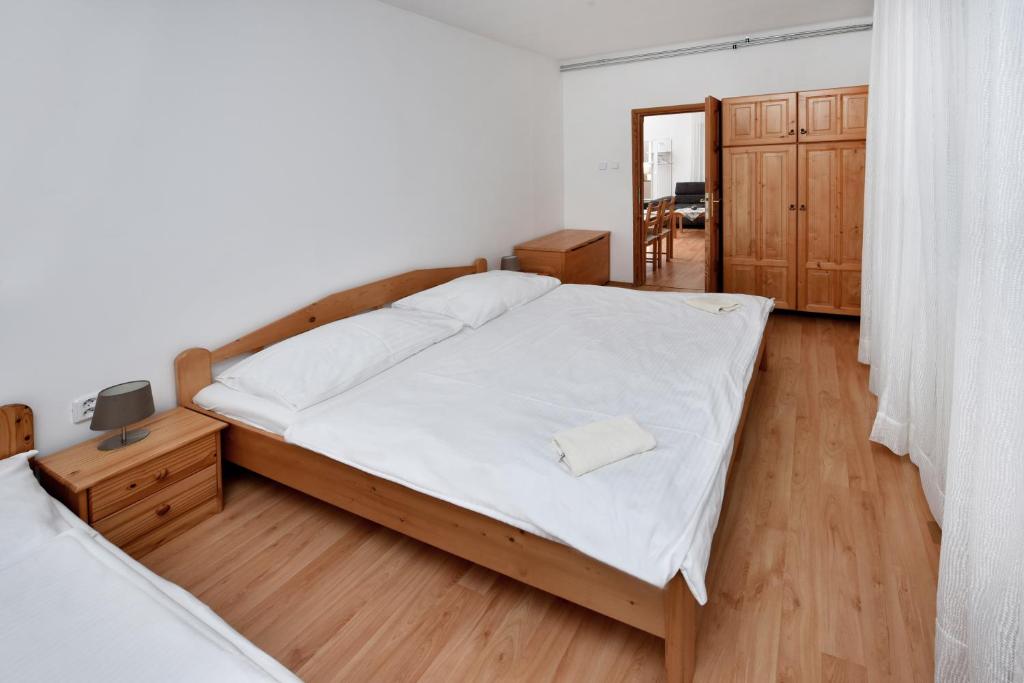 Postel nebo postele na pokoji v ubytování Apartmany ZEA