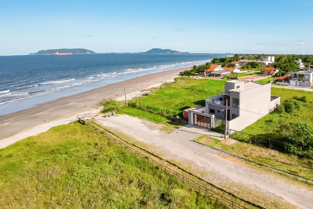 an aerial view of a house on the beach at Canto da Nega - Seu canto na Praia! in Itapoa