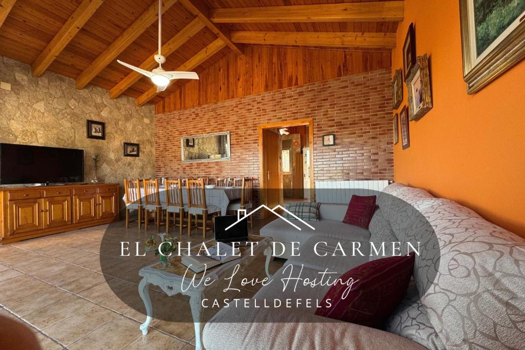 a living room with a bed and a dining room at Chalet de Carmen in Castelldefels