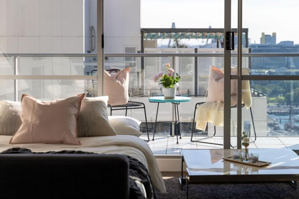 a living room with a couch and a table at A Spacious 2BR Apt with an Amazing View Over Darling Harbour in Sydney