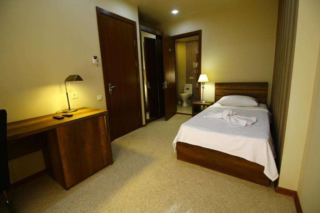 Postel nebo postele na pokoji v ubytování Sani Hotel